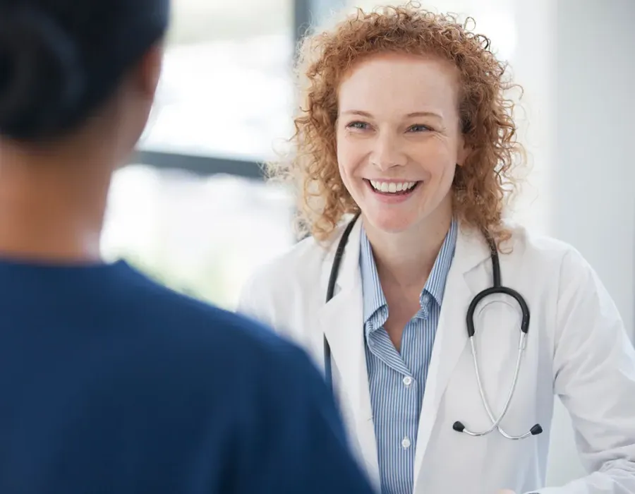 Public Health Nurse Smiling with Patient in Office